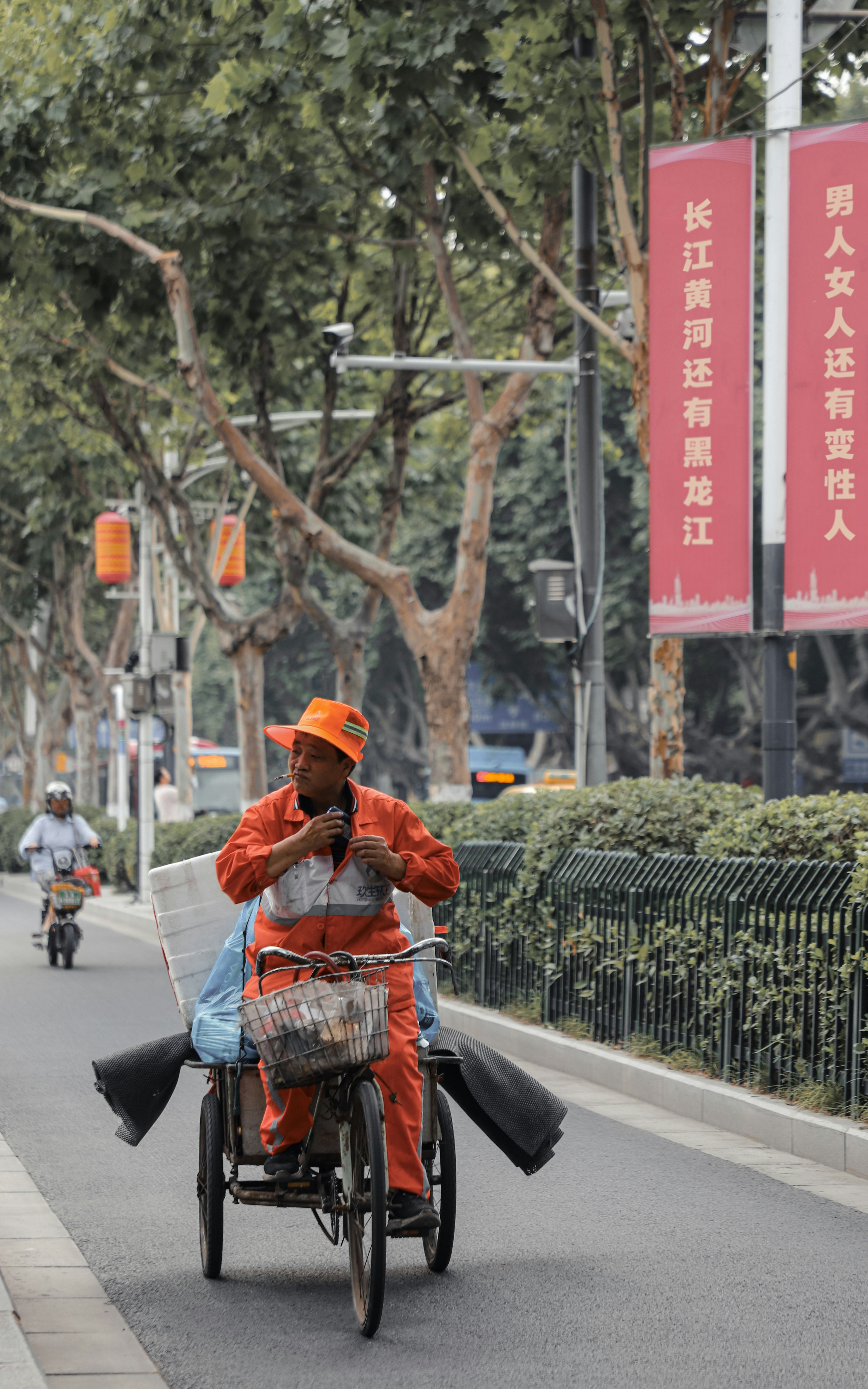 man in brown leather jacket and brown hat riding on bicycle on road during daytime